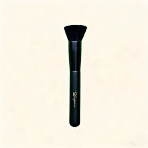 Black flat-top foundation makeup brush with Sophienia brand name on handle against cream background