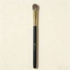 Sophienia eyeshadow blending brush with soft gray bristles, gold ferrule, and black handle on cream background